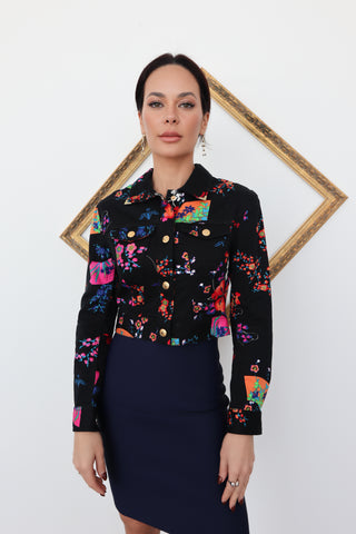 Versace x H&M black cropped jacket with vibrant floral print and gold buttons, photographed on model for Luxury Kulture.