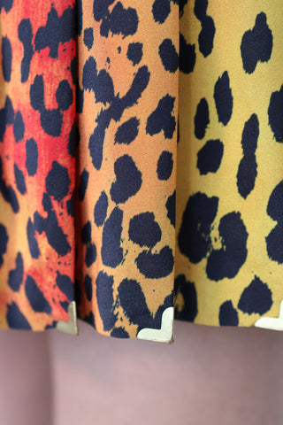 Versace x H&M 2011 leopard print silk mini skirt with central pink sunset graphic and baroque detailing