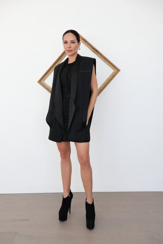 Balmain x H&M black sleeveless tuxedo vest with satin lapels – tailored structured fit, size S, available at Luxury Kulture.