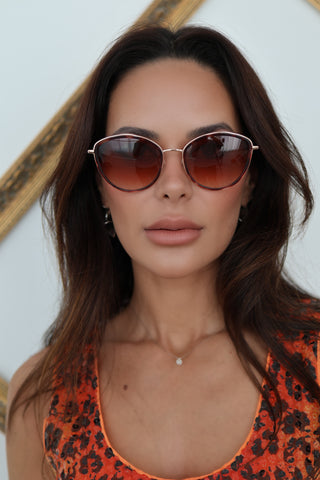 Longchamp L0170S rose gold sunglasses with red Havana accents and light pink lenses