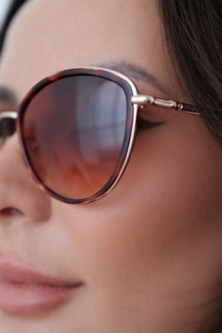 Longchamp L0170S rose gold sunglasses with red Havana accents and light pink lenses