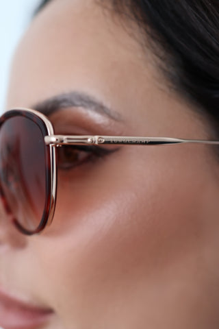 Longchamp L0170S rose gold sunglasses with red Havana accents and light pink lenses