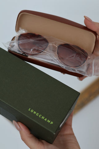 Longchamp L0170S rose gold sunglasses with red Havana accents and light pink lenses