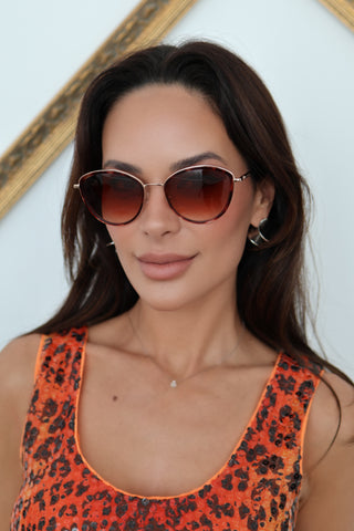 Longchamp L0170S rose gold sunglasses with red Havana accents and light pink lenses