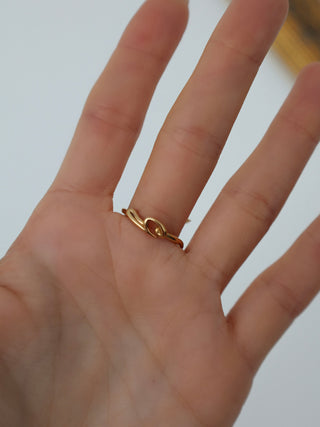 Burberry gold hook pavé ring with clear crystal detailing displayed with original box and dust bag