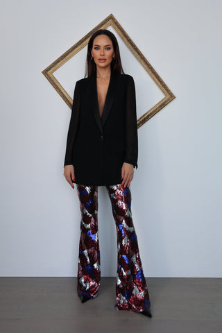 Nadine Merabi geometric sequin flare trousers in burgundy red, blue and silver with a high-waisted fit and statement flared leg silhouette.