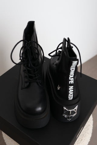 Naked Wolfe Saturn black leather platform lace-up ankle boots in Size 8 featuring a 160mm platform sole, metallic Wolfe head heel detail and signature NAKED WOLFE branding, displayed with the original box and tags.