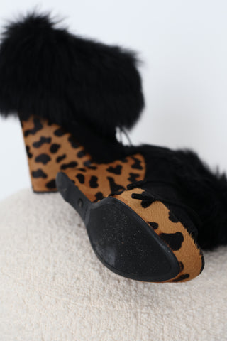 Prada black suede peep-toe wedge ankle boots in EU Size 39 featuring tonal lace-up fronts, plush black fur ankle trim and sculptural leopard-print haircalf platform wedge heels.