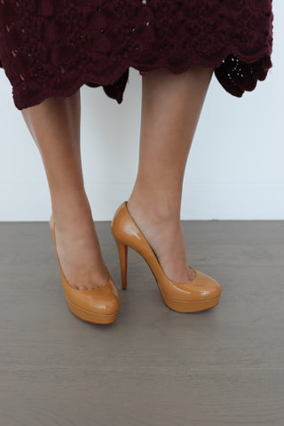 Christian Louboutin beige Bianca patent pumps with red soles, 13.5 cm heel, photographed for Luxury Kulture.