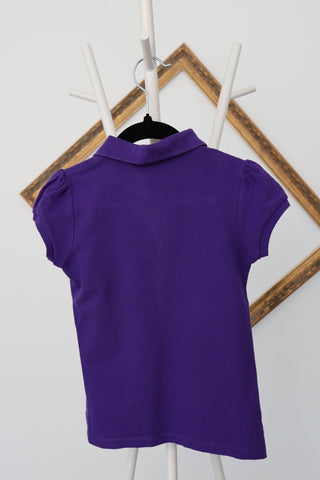 Ralph Lauren girls purple polo shirt with ruffled placket and green embroidered logo.