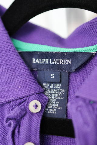 Ralph Lauren girls purple polo shirt with ruffled placket and green embroidered logo.