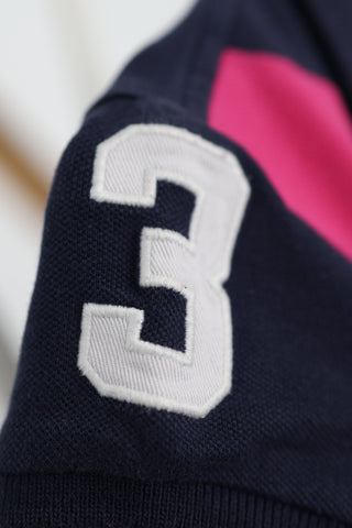 Ralph Lauren girls navy polo shirt with pink diagonal stripe and embroidered pony logo.