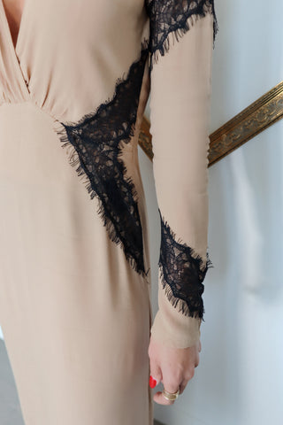 For Love & Lemons nude full-length dress with a plunging V-neckline, long sleeves and contrasting black eyelash lace detailing throughout.
