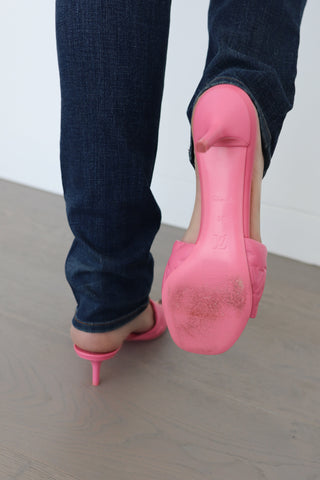 Louis Vuitton candy pink lambskin monogram mules, size 38, photographed on model showing embossed strap and slim heel.