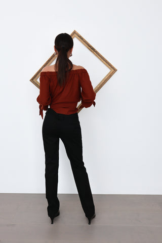 See By Chloé black slim-straight tailored pants with back bow detail, shown from multiple angles on model.