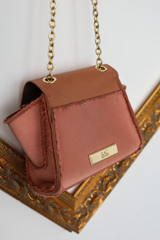 Zac Posen rose pink mini structured handbag with gold chain strap and clasp closure.