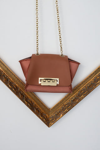 Zac Posen rose pink mini structured handbag with gold chain strap and clasp closure.