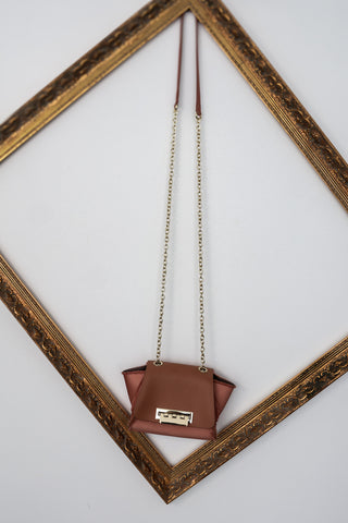 Zac Posen rose pink mini structured handbag with gold chain strap and clasp closure.