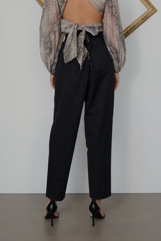Acne Studios black tailored trousers featuring a mid-rise waist, tapered-leg silhouette, front pleat detailing and minimalist Scandinavian design.