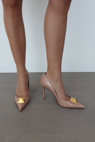 Valentino beige patent leather heels with gold pyramid stud, size 40, shown on model.