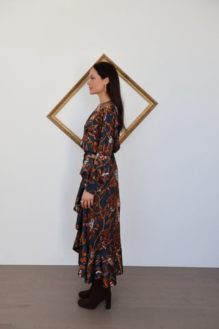 Johanna Ortiz long-sleeve silk dress with draped asymmetric hem and botanical print, photographed on model for Luxury Kulture.