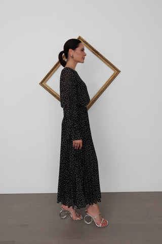 Model wearing a black Emporio Armani long dress with white polka dots, featuring a bateau neckline, long sleeves and pleated skirt, shown from multiple angles.