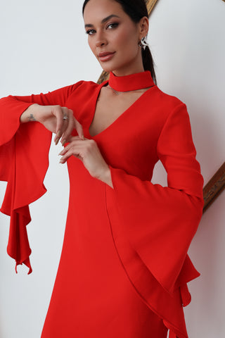 Woman wearing a red Carla Zampatti midi dress with dramatic tiered sleeve and V neckline.