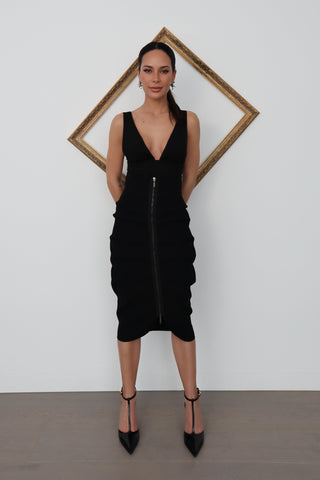 Black Maticevski bandage-style midi skirt with tiered draped panels and a full-length front zipper, shown on model from multiple angles including close-up fabric and zip details.