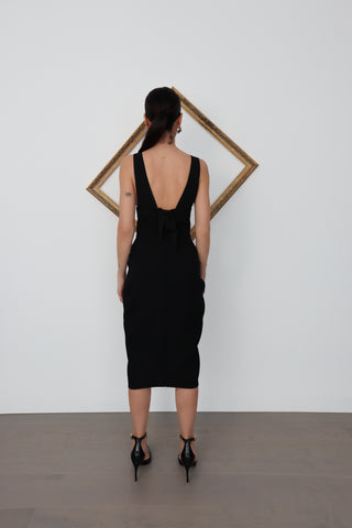 Black Maticevski bandage-style midi skirt with tiered draped panels and a full-length front zipper, shown on model from multiple angles including close-up fabric and zip details.