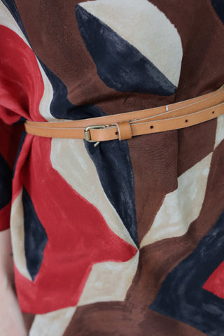 Ralph Lauren silk geometric print blouse with waist belt detail and relaxed fit silhouette.