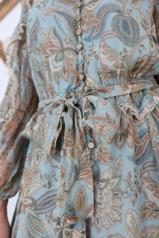 Zimmermann blue paisley floral silk playsuit with ruffle details lace trim and waist tie.