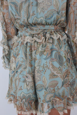 Zimmermann blue paisley floral silk playsuit with ruffle details lace trim and waist tie.