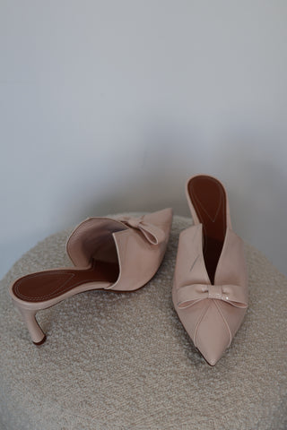 Zimmermann cream patent leather pointed toe mules with bow detail and mid-height heel.