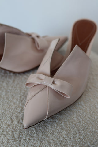 Zimmermann cream patent leather pointed toe mules with bow detail and mid-height heel.