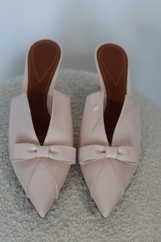 Zimmermann cream patent leather pointed toe mules with bow detail and mid-height heel.