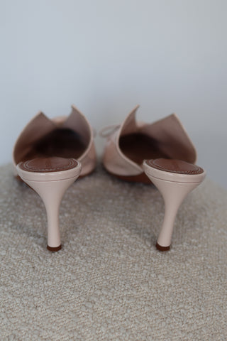 Zimmermann cream patent leather pointed toe mules with bow detail and mid-height heel.