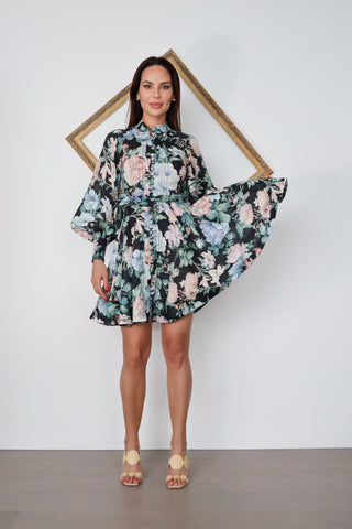 Zimmermann Verity Rouleau Short Floral Dress with floral print, high neckline, fabric-covered buttons, balloon sleeves, and self-tie waist belt.