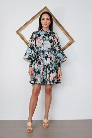 Zimmermann Verity Rouleau Short Floral Dress with floral print, high neckline, fabric-covered buttons, balloon sleeves, and self-tie waist belt.