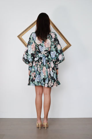 Zimmermann Verity Rouleau Short Floral Dress with floral print, high neckline, fabric-covered buttons, balloon sleeves, and self-tie waist belt.