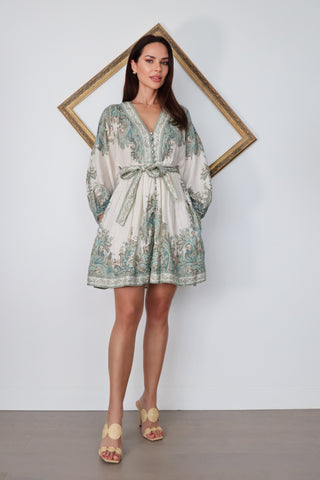 Zimmermann Brighton Paisley Mini Dress in turquoise paisley print with fabric-covered buttons, long blouson sleeves, self-tie waist belt, and linen fabrication.