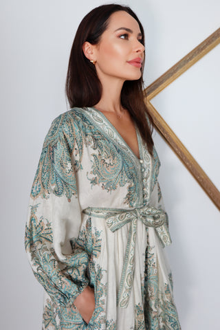 Zimmermann Brighton Paisley Mini Dress in turquoise paisley print with fabric-covered buttons, long blouson sleeves, self-tie waist belt, and linen fabrication.