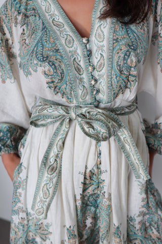 Zimmermann Brighton Paisley Mini Dress in turquoise paisley print with fabric-covered buttons, long blouson sleeves, self-tie waist belt, and linen fabrication.