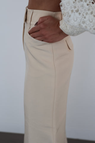 Zimmermann beige flared designer pants in size 0, high-waisted with pockets, shown styled on model.