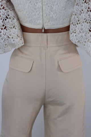 Zimmermann Kaleidoscope beige flared designer pants in size 0, high-waisted with pockets, shown styled on model.