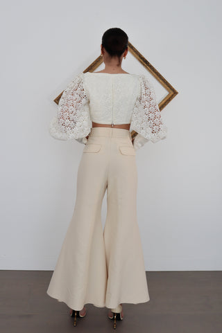 Zimmermann Kaleidoscope beige flared designer pants in size 0, high-waisted with pockets, shown styled on model.