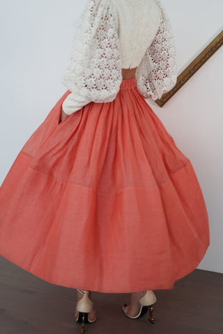 Zimmermann pink linen midi skirt in size 0 shown on model