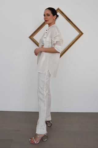 Close-up and full-length photos of Zimmermann transparent white sequin pants worn with white shirt and silver top.