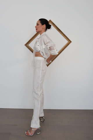 Close-up and full-length photos of Zimmermann transparent white sequin pants worn with white shirt and silver top.