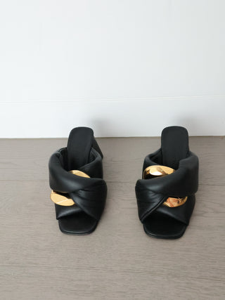 JW Anderson black leather Chain Twist mule with oversized gold chain detail and block heel, photographed from multiple angles.