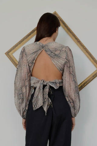 Zimmermann Corsage Pleat Bodice Top in python print featuring a plunging neckline, pleated bodice, long balloon sleeves and dramatic open-back tie closure in lightweight silk.